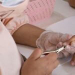 Close-up of a professional manicure session focusing on nail care and hygiene.
